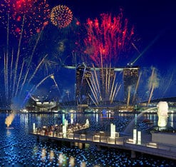 A picture of fireworks over a harbor. 